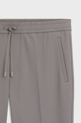 Tapered fit-byxor i vattenavvisande stretchmaterial, M&ouml;rkgr&aring;