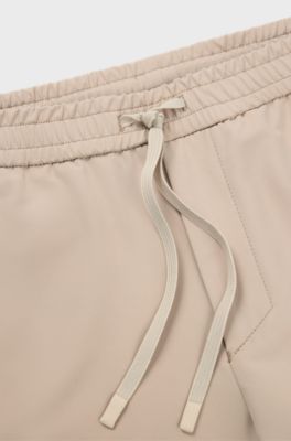 Tapered fit bukser i vandskyende stof med str&aelig;k, Beige