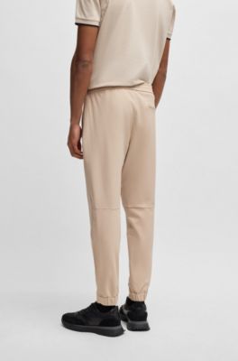 Tapered fit bukser i vandskyende stof med str&aelig;k, Beige