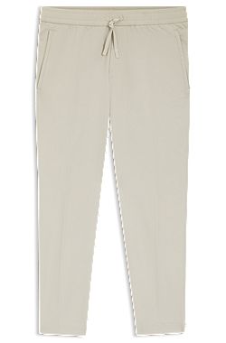 Pantalones tapered fit en tejido elástico hidrófugo