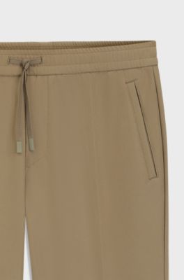 Tapered fit-byxor i vattenavvisande stretchmaterial, Beige