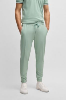 Pantalones tapered fit de tejido el&aacute;stico repelente al agua, Cal