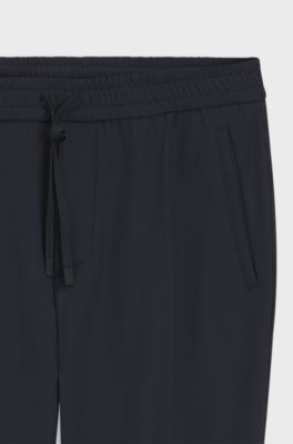 Pantalones tapered fit de tejido el&aacute;stico repelente al agua, Azul oscuro