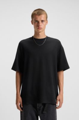 T-Shirt aus Baumwoll-Jersey mit blauem Logo-Aufn&auml;her, Schwarz