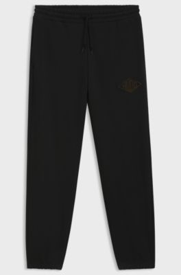 Cotton-terry tracksuit bottoms with embroidered logo, Black
