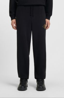 Cotton-terry tracksuit bottoms with embroidered logo, Black
