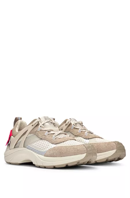 Mixed-material trainers with decorative reflective effects