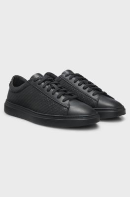 Leather trainers with embossed monograms, Black