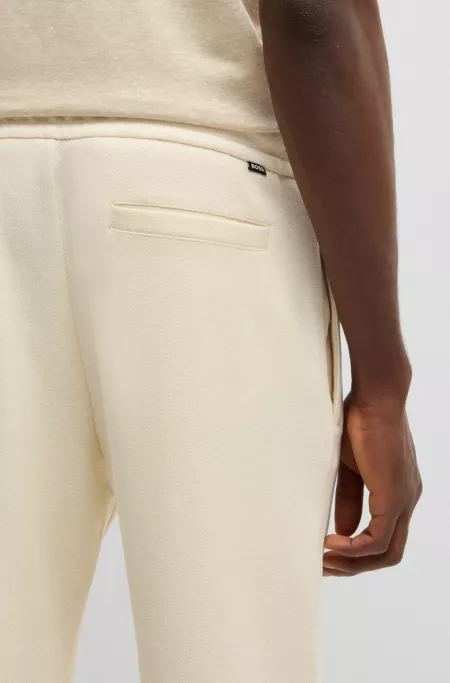 Modern-fit tracksuit bottoms in cotton-linen piqué