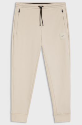 Stretch-cotton-blend tracksuit bottoms with logo patch, Light Beige