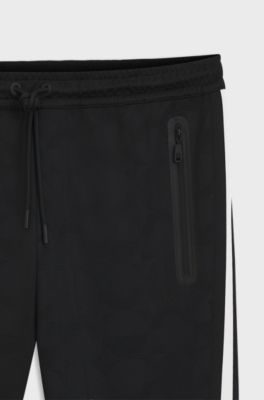 Relaxed-fit tracksuit bottoms with jacquard-woven circles, Black