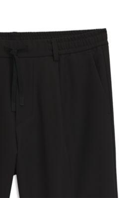 Tapered-fit trousers in water-repellent stretch fabric, Black