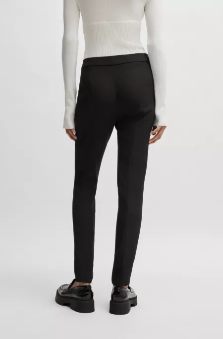 Slim-fit trousers in stretch fabric with logo rivet