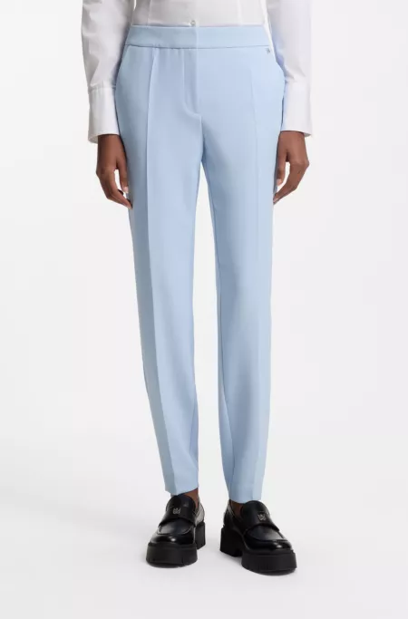 Slim-fit trousers in stretch fabric with logo rivet