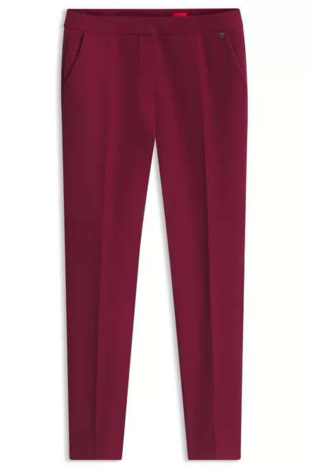 Slim-fit trousers in stretch fabric with logo rivet