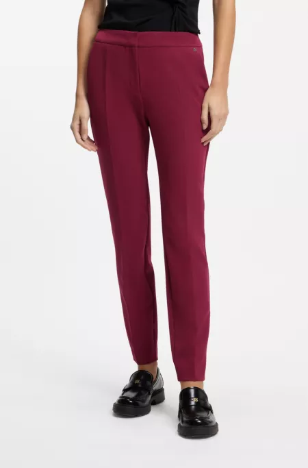 Slim-fit trousers in stretch fabric with logo rivet