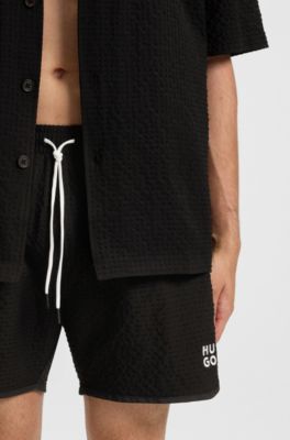Waffle-structured swim shorts with embroidered stacked logo, Black