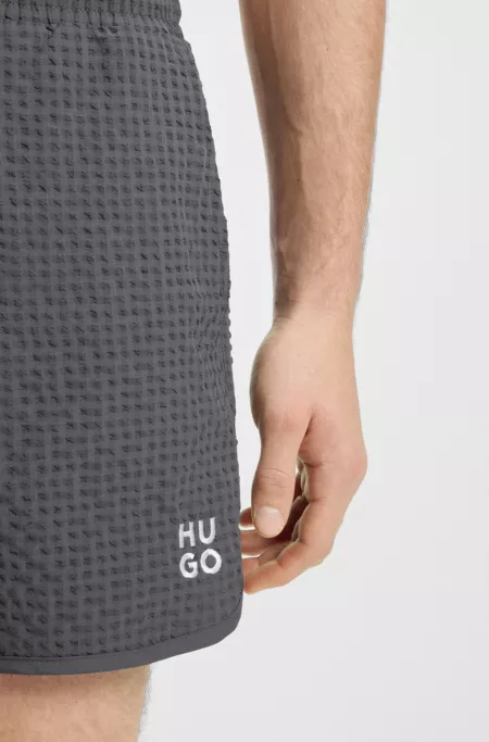 Waffle-structured swim shorts with embroidered stacked logo