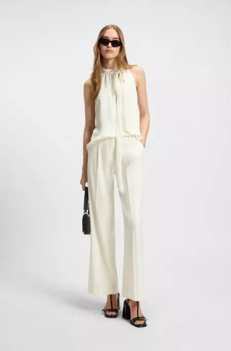 Sleeveless blouse in satin with tie neck