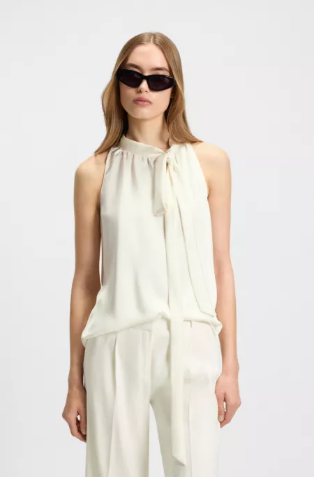 Sleeveless blouse in satin with tie neck