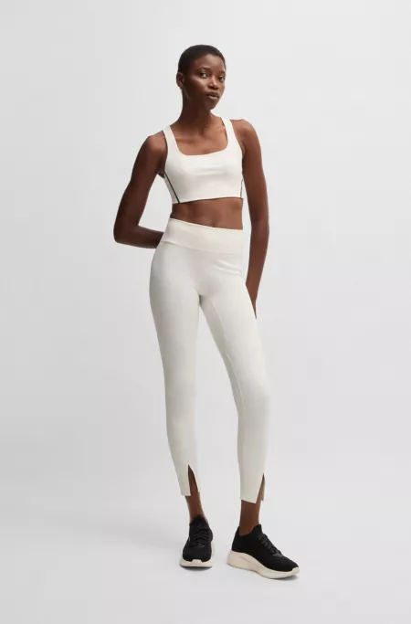 Active leggings in stretch interlock fabric with slit hems