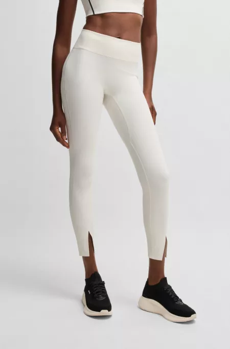 Active leggings in stretch interlock fabric with slit hems