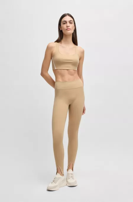 Active leggings in stretch interlock fabric with slit hems