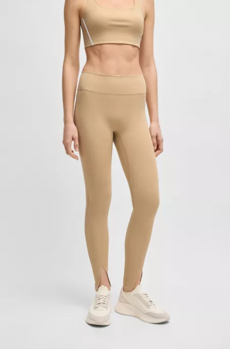 Active leggings in stretch interlock fabric with slit hems