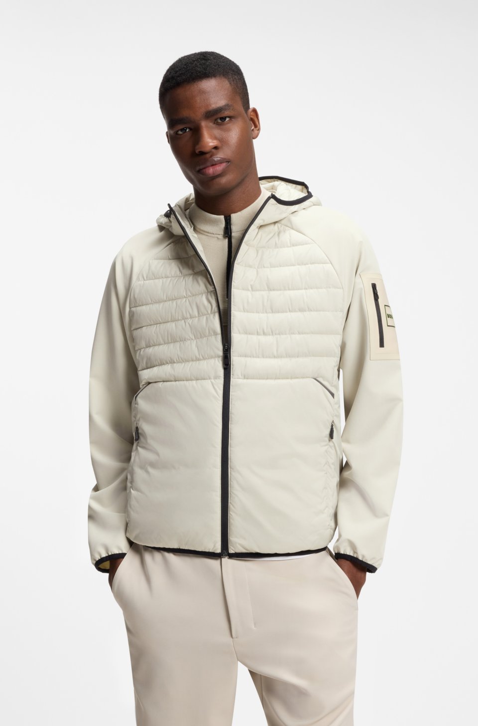 Water-repellent jacket with zipped sleeve pocket