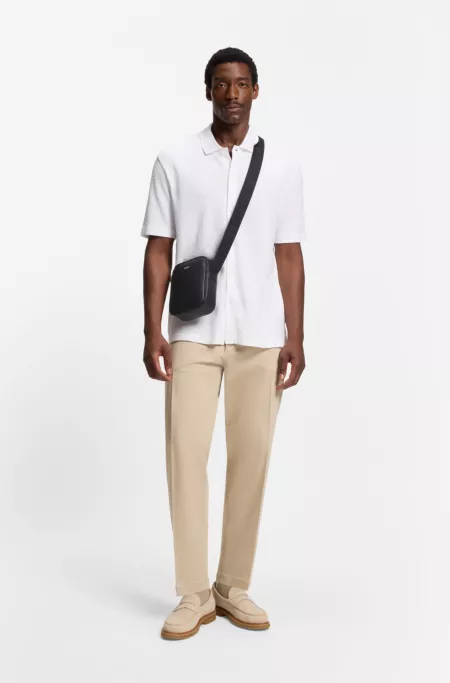 Reporter bag with monogram-patterned front pocket