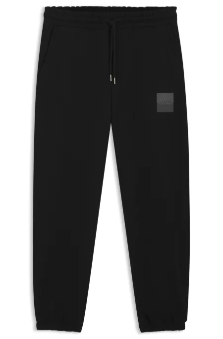 Cotton-terry tracksuit bottoms with split logo