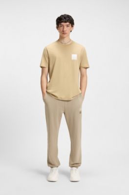 Cotton-terry tracksuit bottoms with split logo, Beige