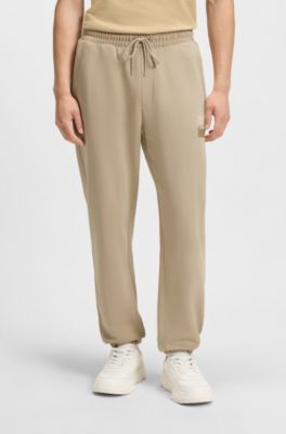 Cotton-terry tracksuit bottoms with split logo, Beige