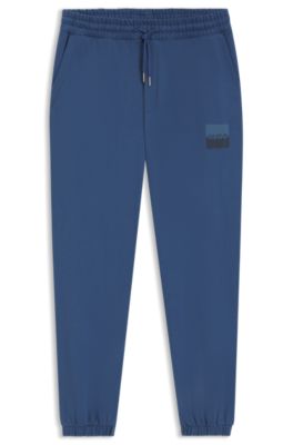 Cotton-terry tracksuit bottoms with split logo, Blue