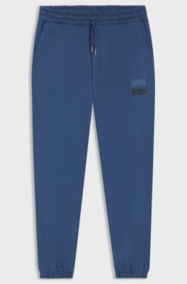 Cotton-terry tracksuit bottoms with split logo, Blue