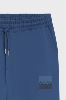 Cotton-terry tracksuit bottoms with split logo, Blue
