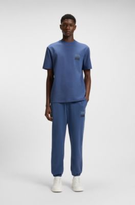 Cotton-terry tracksuit bottoms with split logo, Blue