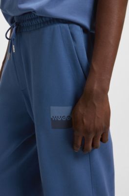 Cotton-terry tracksuit bottoms with split logo, Blue