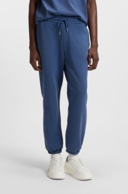Cotton-terry tracksuit bottoms with split logo, Blue