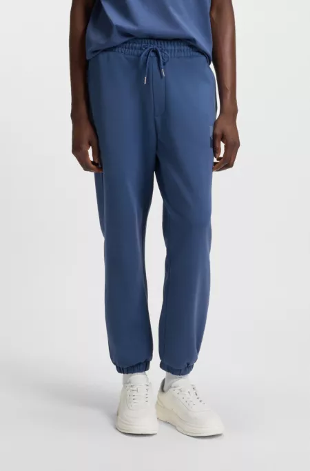 Cotton-terry tracksuit bottoms with split logo