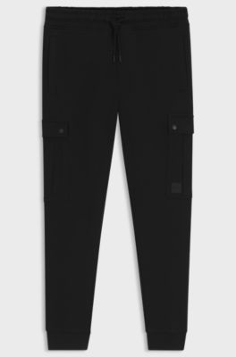 Relaxed-fit cotton-terry tracksuit bottoms with cargo pockets, Black