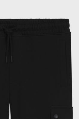 Relaxed-fit cotton-terry tracksuit bottoms with cargo pockets, Black