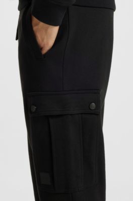 Relaxed-fit cotton-terry tracksuit bottoms with cargo pockets, Black