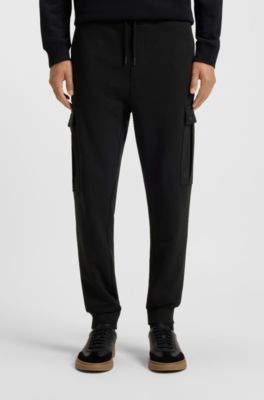 Relaxed-fit cotton-terry tracksuit bottoms with cargo pockets, Black