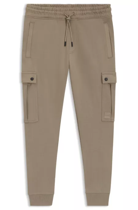 Relaxed-fit cotton-terry tracksuit bottoms with cargo pockets