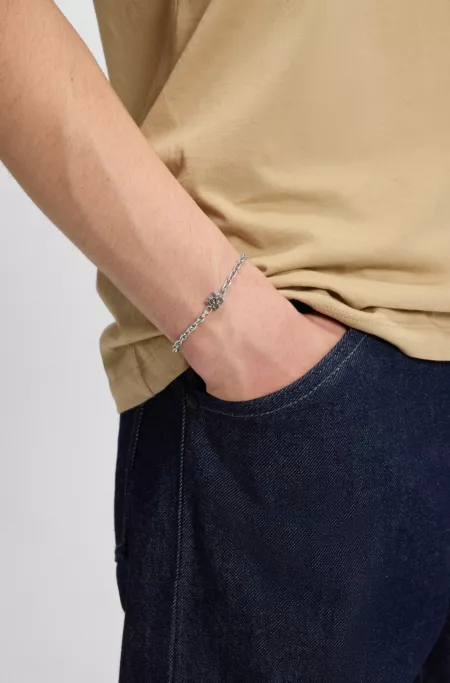Chain cuff with stacked-logo plaque