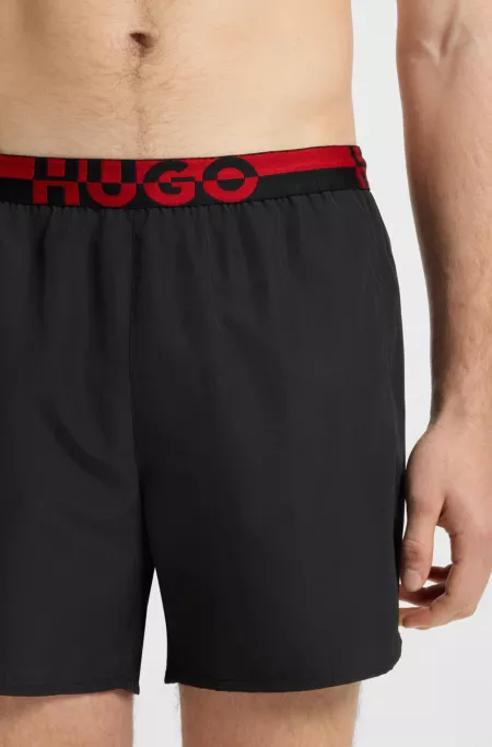 Swim shorts with split-logo waistband