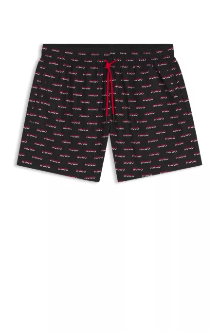 Bañador tipo shorts con estampado integral de logos divididos