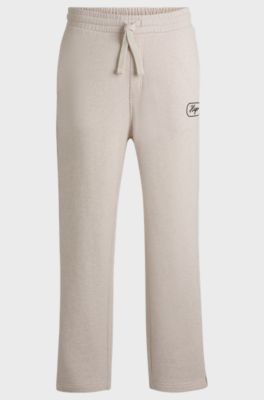 Cotton-terry tracksuit bottoms with embroidered graphics, Natural