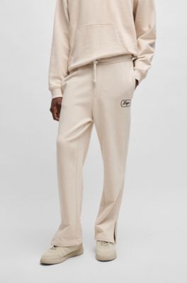 Cotton-terry tracksuit bottoms with embroidered graphics, Natural